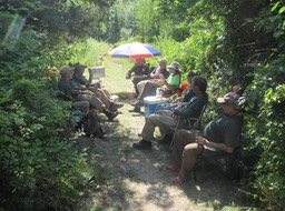 23 End of day crew meeting in the shade